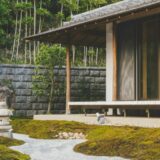 wooden house with glass sliding door beside trees at daytime