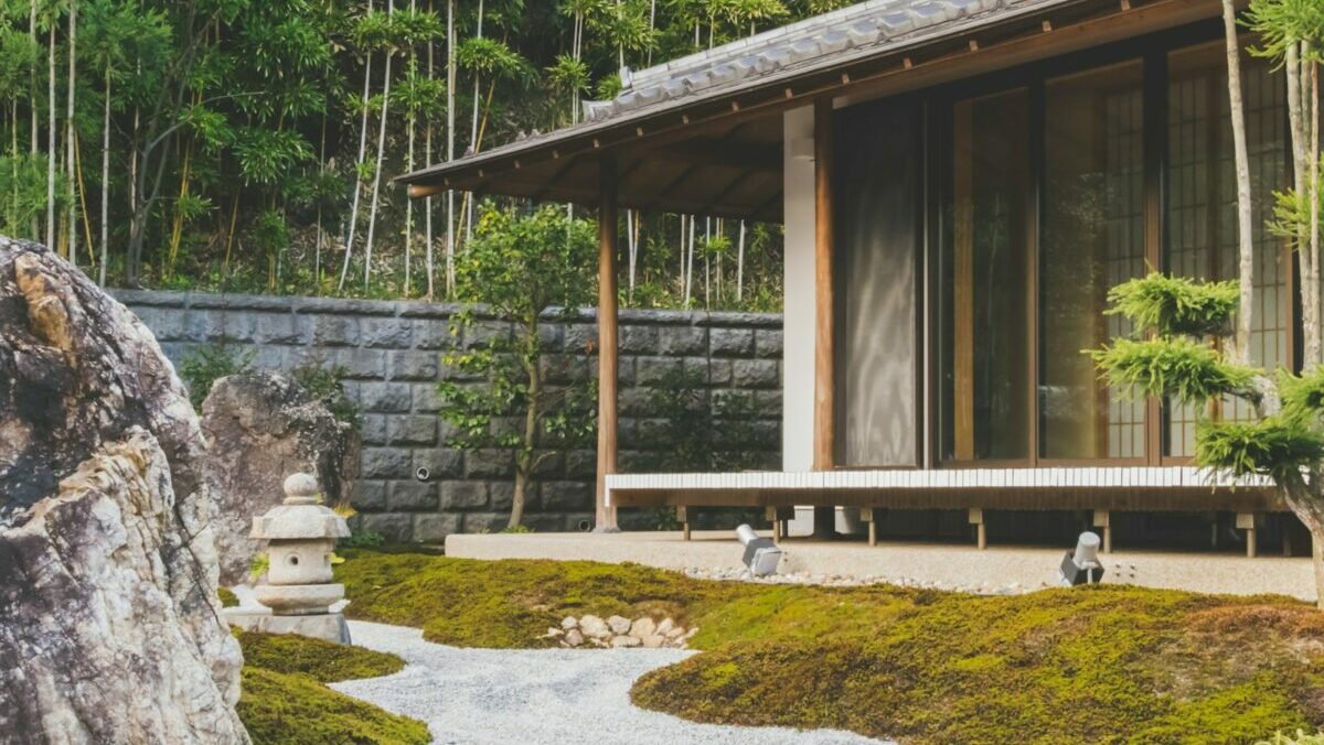 wooden house with glass sliding door beside trees at daytime