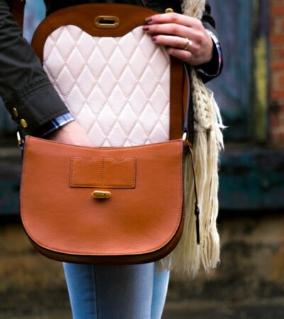 woman wearing red leather crossbody bag