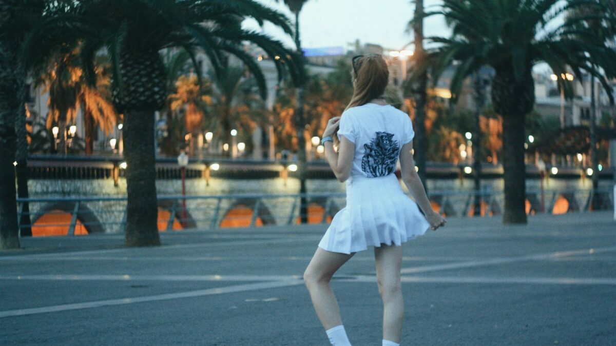 woman wearing white mini skirt standing on concrete surface