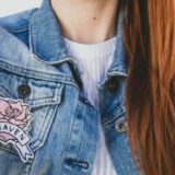 woman wearing blue denim faded jacket