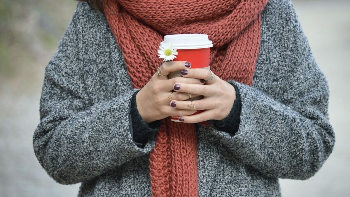 person holding red and white disposable cup