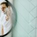 man shaving in front of mirror